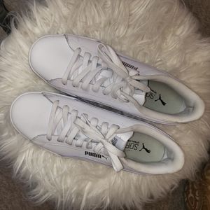 Gently used white Puma sneakers w/yellow,lavender and pink piping. Women's size9